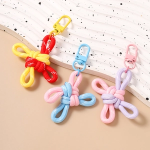 Three Chinese knot keychains with metal lobster clasps in red, blue, and purple hues