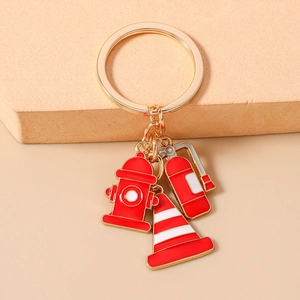 Detail showing firefighter keychain with fire hydrant, extinguisher and cone charms