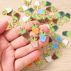 Macro detail of colorful enamel cactus pot charms for DIY jewelry making and earrings