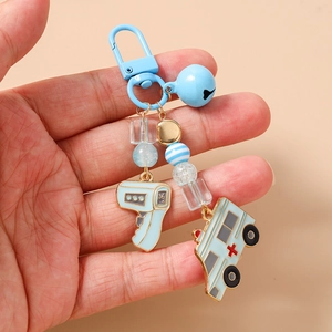 Detail showing blue beaded keychain with medical thermometer and ambulance charms