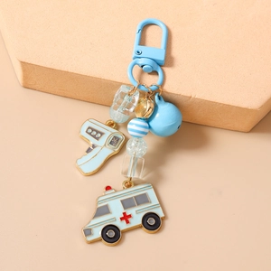 Detail of blue ambulance and thermometer charms on a beaded medical keychain