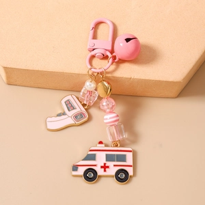 Detail view of pink medical keychain with thermometer, ambulance charms and beaded chain