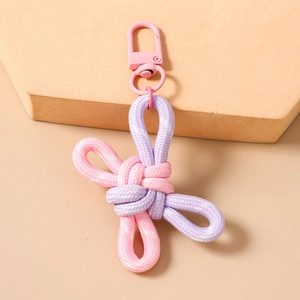 Detail of pink and purple hand-woven knot pendant with a matching pink metal lobster clasp