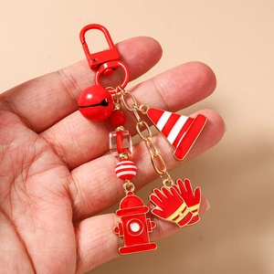Detail of red fire safety keychain with enamel cones, fire hydrants and red lobster clasp