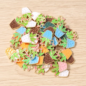 Macro shot of colorful enamel potted plant charms with gold rings for DIY jewelry