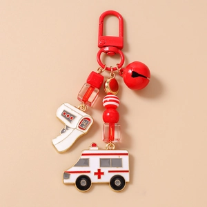Close-up of red ambulance and thermometer pendants on a beaded metal keychain