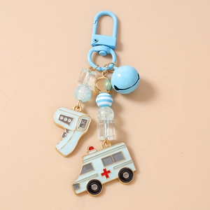 Detail of medical theme keychain with ambulance charm, thermometer and blue beads