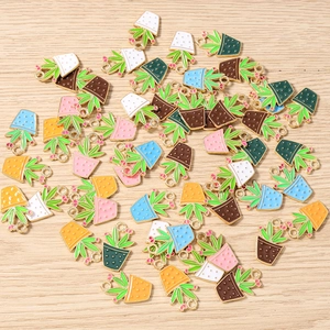 Flat lay of colorful enamel succulent charms with golden alloy edges for DIY jewelry making