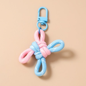 Close-up of pink and blue woven Chinese knot keychain with a blue carabiner clip