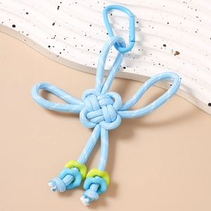 Detail of light blue hand-woven Chinese knot keychain with a matching metal carabiner