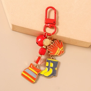 Detail showing red lobster clasp with firefighter gear charms and matte bell pendant