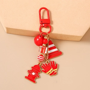 Detailed view of red firefighter keychain with charms and beads on aesthetic backdrop