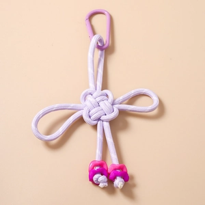 Detail of lavender woven Chinese knot keychain with purple carabiner and pastel beads