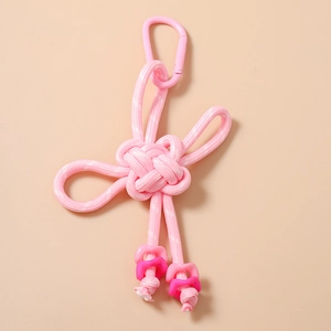 Detail of pink Chinese knot keychain with floral beads and a secure snap hook attachment