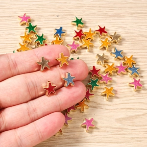 Dettaglio macro di ciondoli a stella marina colorati placcati oro per gioielli fai-da-te