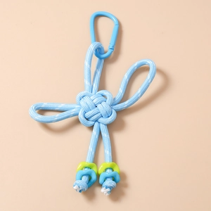 Detail of blue braided knot keychain with clover design and metal climbing hook
