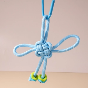Detailed view of hand-woven blue Chinese knot keychain with square beads and carabiner