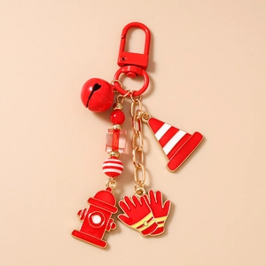 Detail of firefighter keychain with red traffic cone, fire hydrant, and gloves charms