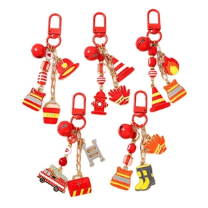 Set of fire engine keychains with red charms including fire truck and helmet