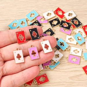 Detailed view of colorful enamel ace of clubs charms with metal rings for jewelry making
