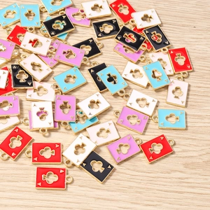 Macro view of colorful enamel ace of clubs playing card charms for DIY jewelry making