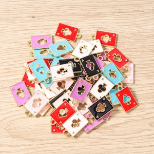 Detail of colorful enamel poker ace charms with hollow clover motifs for jewelry making