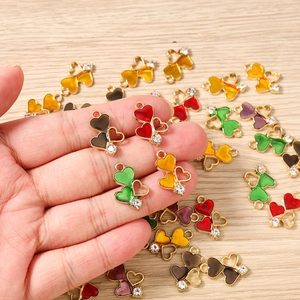 Detailed close-up of colorful heart charms with gold plating and sparkling rhinestones
