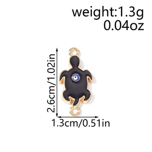 Detail view of turtle charm with evil eye design including size and weight specs