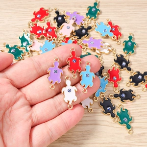 Macro detail of turtle evil eye charms in assorted colors for DIY jewelry making