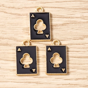Macro view of black enamel Ace of Clubs playing card pendants for DIY jewelry