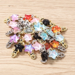Vue à plat de breloques colorées en résine chat et étoile pour bijoux DIY sur bois