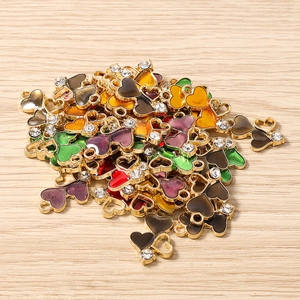 Close-up of colorful heart charms with gold plating and rhinestones for DIY jewelry making