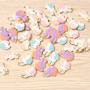 Macro shot of colorful enamel rabbit pendants for DIY jewelry making and crafts