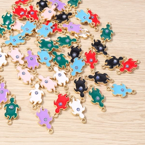 Detail view of colorful turtle charms with evil eye design for DIY jewelry making