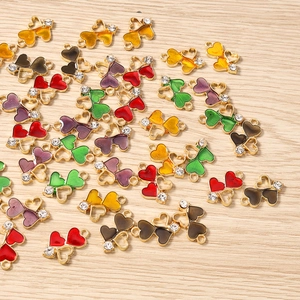 Detailed macro view of colorful enamel heart pendants with rhinestones on wood