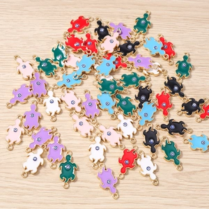 Detail of colorful enamel turtle charms with evil eye accents for DIY jewelry making