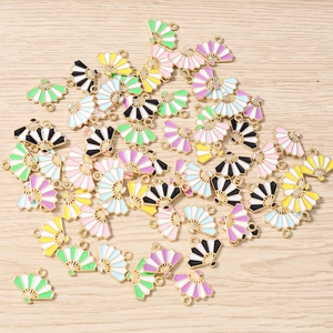 Detailed macro view of colorful enamel fan-shaped alloy charms for DIY jewelry making