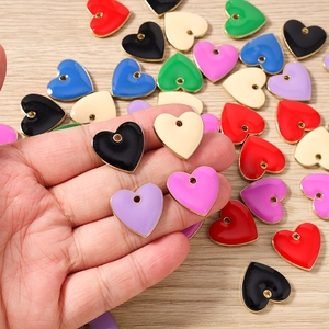 Macro detail of colorful enamel heart pendants for DIY necklaces and bracelets making
