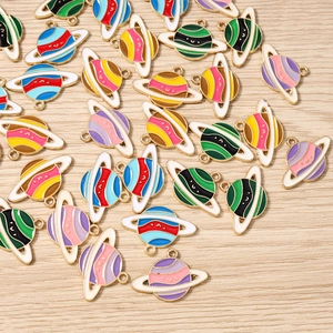 Detailed close-up of colorful enamel planet charms in multiple shades for DIY jewelry making