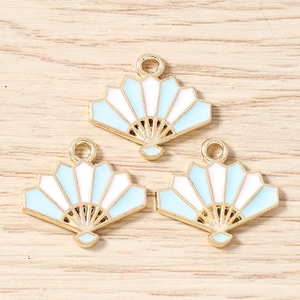 Macro view of three light blue enamel folding fan pendants for DIY jewelry making