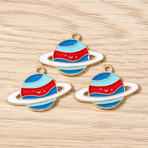 Detail of colorful enamel planet pendants with gold-plated metal loops for DIY jewelry