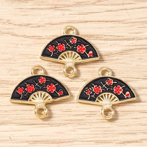 Detail of fan-shaped black enamel charms with red flower pattern and double rings