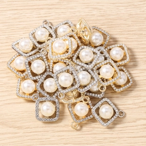 Close-up of square rhinestone geometric pendants with pearl center for DIY jewelry making