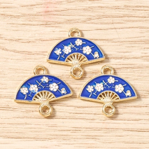 Detail of blue enamel fan pendants with white plum blossoms for DIY jewelry making