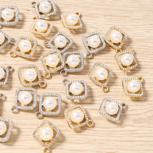 Flat lay of square pearl pendants with rhinestone frames and gold or silver metal bases