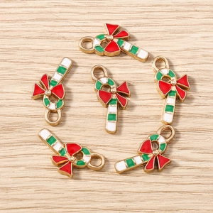 Detailed view of candy cane alloy charms with red bows for Christmas DIY jewelry making