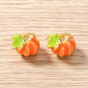 Handmade orange pumpkin charms with green leaves for DIY jewelry making and crafts