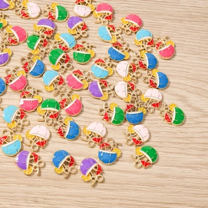 Flat lay of colorful enamel coconut drink charms with umbrella and straw details