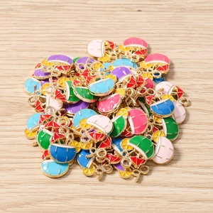 Macro view of colorful enamel cocktail charms with lemon and umbrella for DIY jewelry