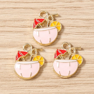 Detailed macro view of enamel coconut cocktail charms with summer umbrella for DIY jewelry